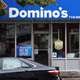 People walk past a Domino’s in Brooklyn, New York. Domino’s made an announcement on Tuesday that it is seeking to fill 20,000 positions at its corporate and franchise stores nationwide.